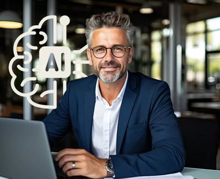 homme derrière un pc portable souriant a coté d'un logo IA